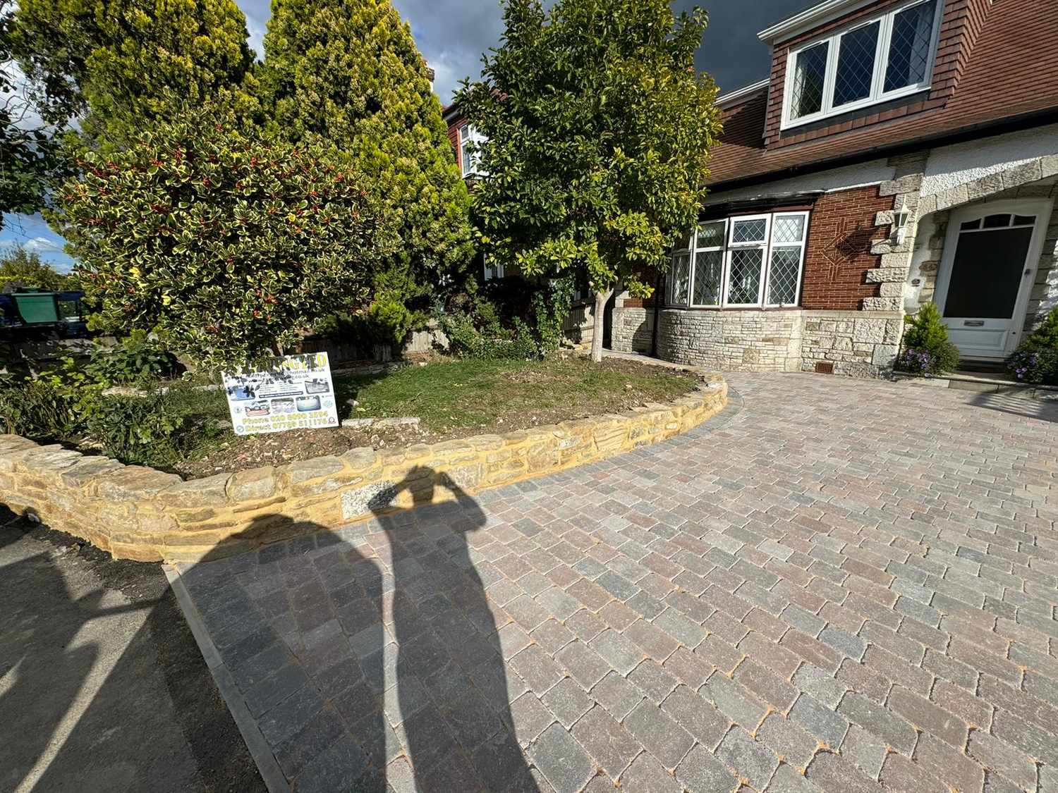 Driveway with a stone garden wall